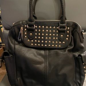 new black leather hand bag with gold studs.